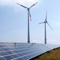 © Armin Kübelbeck Photograph showing solar panels in the foreground and wind turbines in the background. Image courtesy of Armin Kübelbeck.