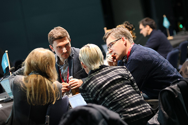 Defra and JNCC colleagues consult during the negotiations © Photo by IISD/ENB | Anastasia Rodopoulou
