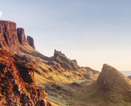 Photograph of a landscape, showing rocky outcrops and a blue sky, copyright IPBES